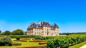 Loire Valley château and vineyards under a blue sky.