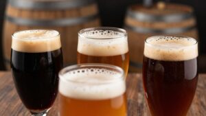Barrel-aged beers in glasses with wine barrels