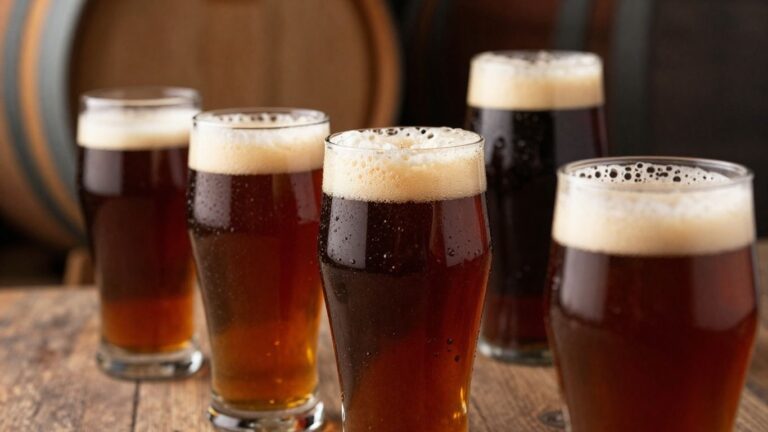 Barrel-aged beers in glasses with wine barrels