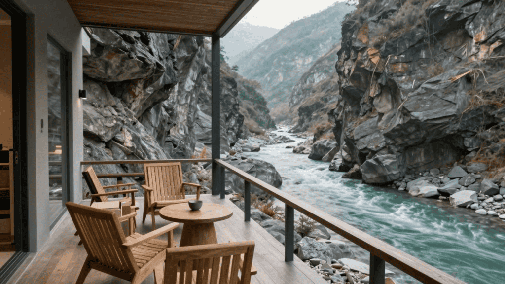 Wooden balcony seating with four chairs and a round table overlooking a rocky river gorge.